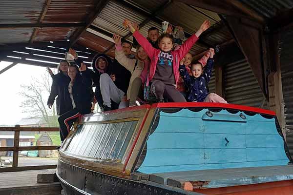 Happy children enjoying their time on a canal boat