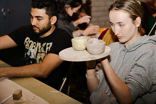 Group of people crafting pottery together