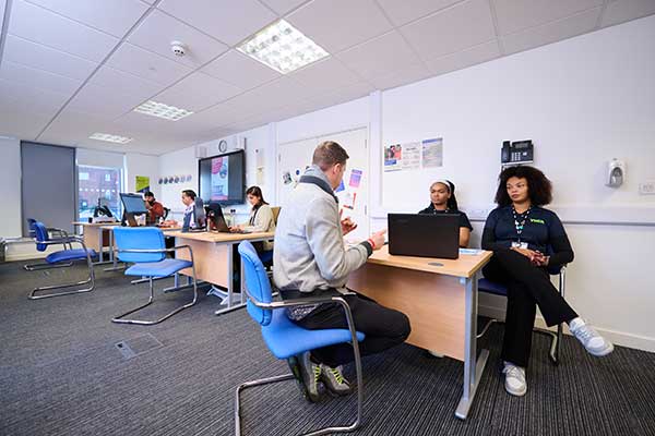 Room of job coaches at Sandwell Youth Hub, meeting with prospective clients.