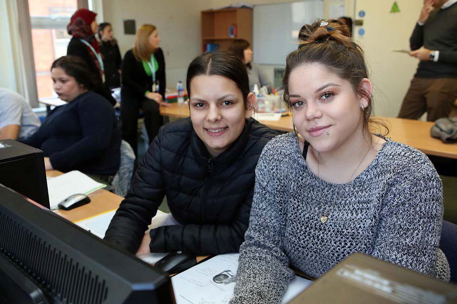 Young girl and YMCA worker adapting a CV to improve employment prospects