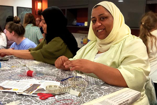 Two muslim women taking part in a craft activity with young girls at YMCA Ys Girls